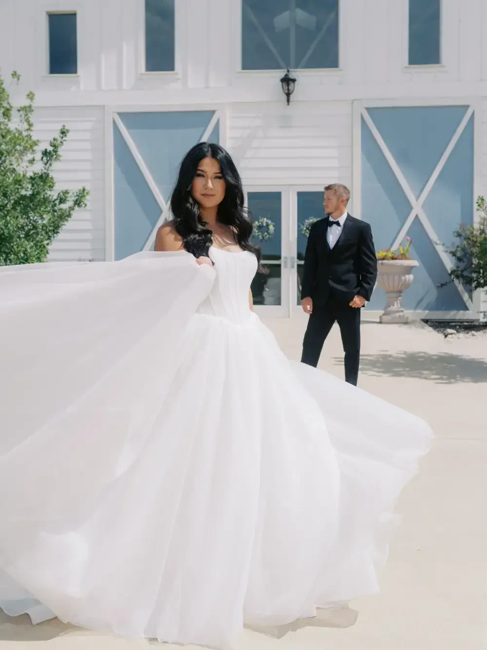 Photo of a bride and a groom kissing while holding a sparkling torches.